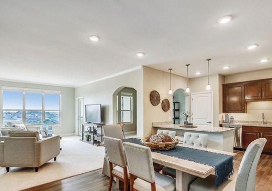 Interior shot of kitchen and dining area inside of an Erickson two-bedroom apartment home.