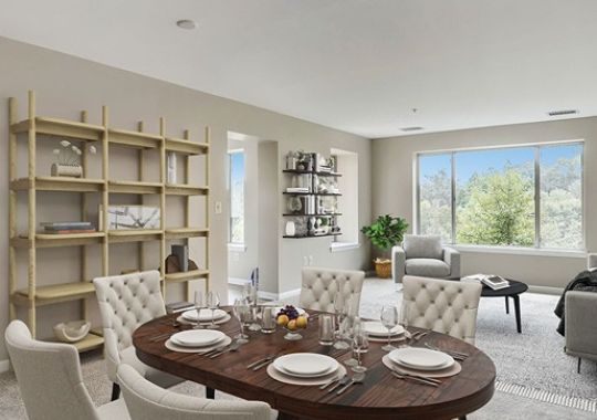 Spacious, furnished, open living room and dining area in an Erickson apartment home.