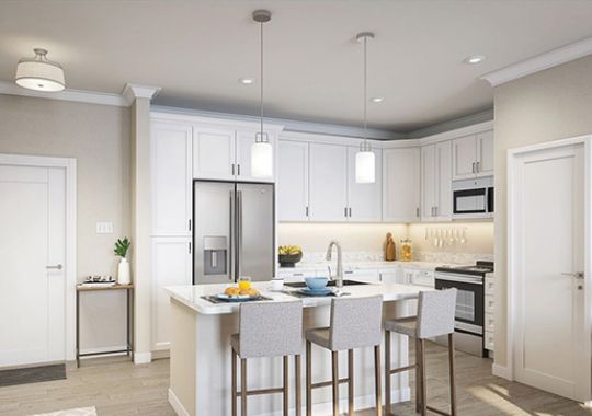Interior shot of a modern kitchen with stainless steel appliance and a breakfast bar.