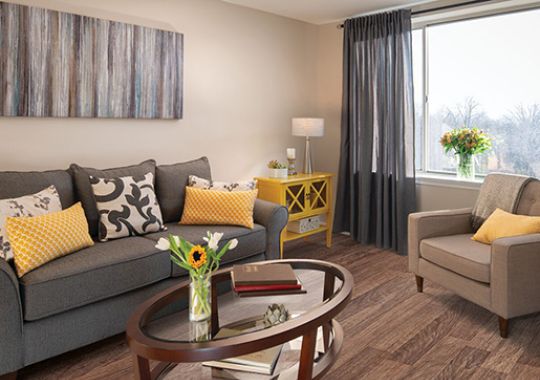 Comfortable and well-furnished living room in an Erickson Senior Living community apartment.