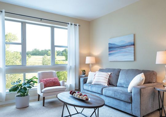 Comfortable and well-furnished living room in an Erickson Senior Living community apartment.