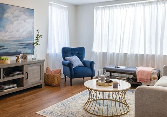 Bright, well-furnished living room in an Erickson Senior Living apartment.