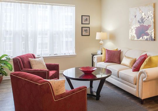 Bright, well-furnished living room in an Erickson Senior Living apartment.
