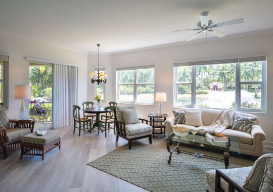 Wide angle shot of a spacious, open living room and dining area in an Erickson apartment.