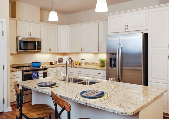 Modern kitchen in an Erickson Senior Living community apartment with stainless steel appliances.