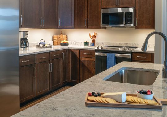 Modern kitchen in an Erickson Senior Living community apartment with stainless steel appliances.