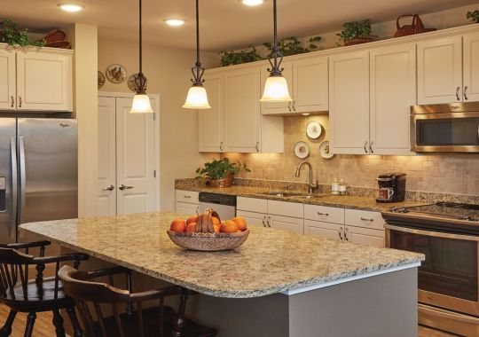 Modern kitchen in an Erickson Senior Living community apartment with stainless steel appliances.
