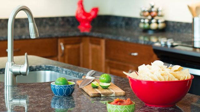 Large kitchen island with the makings for chips and salsa.