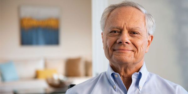 Smiling white male resident at Erickson Senior Living community enjoying a vibrant and fulfilling retirement.