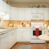 Image of a well lit, modern kitchen with room for a table.