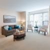 Combined living and dining area of a tastefully decorated apartment.