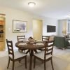 Open concept dining area with round table and four chairs.
