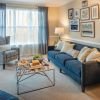 Interior shot of a nicely decorated, open living room in an Erickson two-bedroom apartment home. 