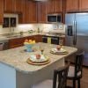 Interior shot of kitchen with stainless steel appliances inside of an Erickson two-bedroom apartment home. 