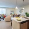 Wide shot of dining room and spacious, open living room. 
