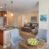 Wide shot of dining room and spacious, open living room. 