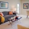 Interior shot of a nicely decorated, open living room in an Erickson two-bedroom apartment home. 