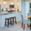 Interior shot of kitchen and breakfast bar inside of an Erickson two-bedroom apartment home. 