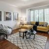 Interior shot of a nicely decorated, open living room in an Erickson two-bedroom apartment home. 