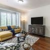 Interior shot of a nicely decorated, open living room in an Erickson two-bedroom apartment home. 