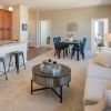 Wide shot of the spacious, bright, furnished living room. 