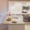 Wide shot of a spacious kitchen with breakfast bar.