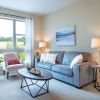 Interior shot of a nicely decorated, open living room in an Erickson two-bedroom apartment home. 