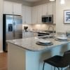 Interior shot of kitchen and breakfast bar inside of an Erickson two-bedroom apartment home. 