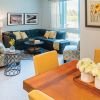 Interior shot of a nicely decorated, open living room in an Erickson one-bedroom apartment home. 