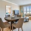 Wide shot of dining room and spacious, open living room. 