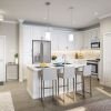 Interior shot of a modern kitchen with stainless steel appliance and a breakfast bar. 