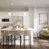 Wide shot of modern kitchen with breakfast bar and seating area. 