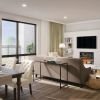 Open, light-filled living room with a balcony view of downtown Bethesda.