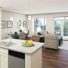 Spacious and inviting apartment living room with cozy seating, tasteful decor, and abundant natural light".