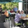 Residents savoring a meal together in the fresh air of our senior living community's outdoor dining area.