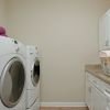 Personal apartment laundry room equipped with large, modern washing and drying machines.