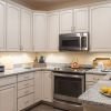 Modern kitchen in an Erickson Senior Living community apartment with stainless steel appliances.