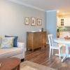 Wide angle shot of a spacious, open living room and dining area in an Erickson apartment.
