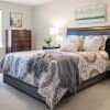 Cozy bedroom in an Erickson Senior Living community apartment with modern furnishings.
