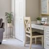 Cozy den with plush armchair, desk and chair, and large window letting in natural light - designed for comfort and relaxation in an Erickson apartment.