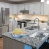 Modern kitchen in an Erickson Senior Living community apartment with stainless steel appliances.