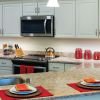 Modern kitchen in an Erickson Senior Living community apartment with updated appliances and counter seating.