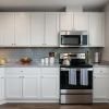 Modern kitchen in an Erickson Senior Living community apartment with stainless steel appliances.
