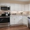 Modern kitchen in an Erickson Senior Living community apartment with stainless steel appliances.