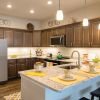 Modern kitchen in an Erickson Senior Living community apartment with updated appliances and counter seating.