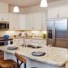 Modern kitchen in an Erickson Senior Living community apartment with stainless steel appliances.