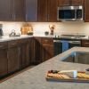 Modern kitchen in an Erickson Senior Living community apartment with stainless steel appliances.