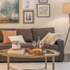 Close-up shot of a modern sofa and wall paintings in a spacious Erickson apartment living room.