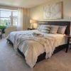 Cozy bedroom in an Erickson Senior Living community apartment with modern furnishings.