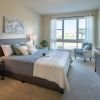 Cozy bedroom in an Erickson Senior Living community apartment with modern furnishings.